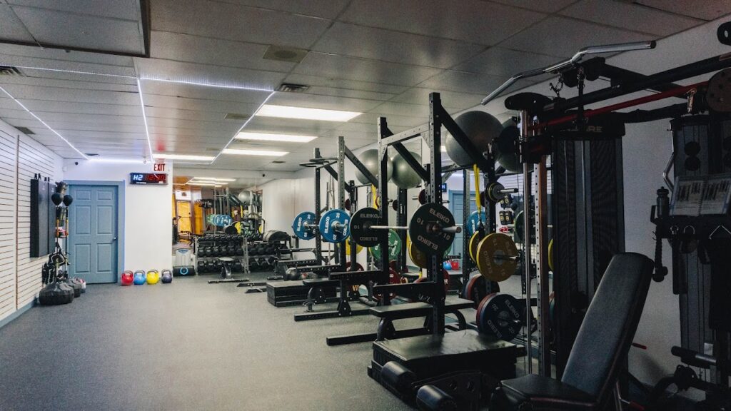 Inside the private studio gym at Atom Athletics in The Junction, featuring professional power racks and weightlifting equipment for local personal training clients.
